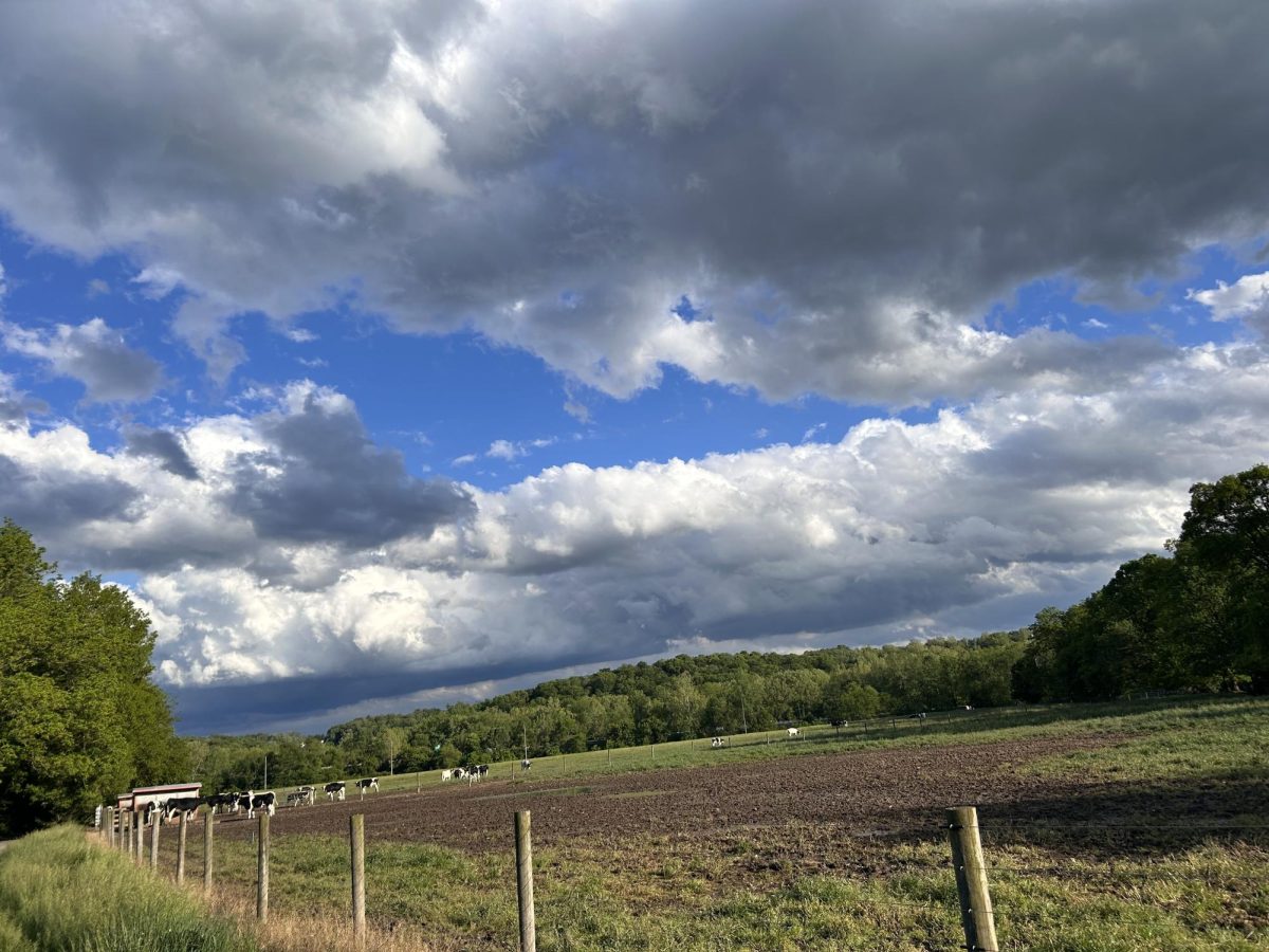Farm by the TJ Evans Bike trail with dark clouds looming above