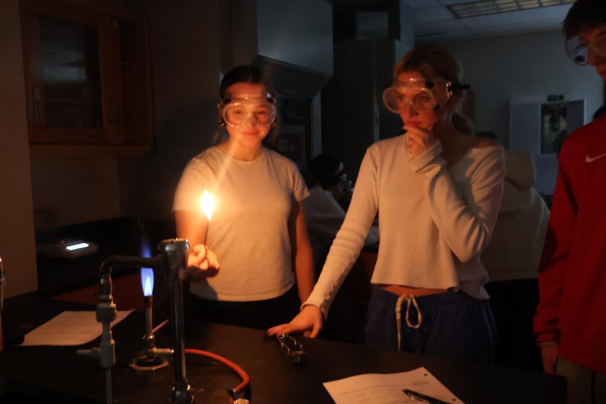 Ivy Miller (11), and Emory Coffee (10) watch intently as they partake in their Chemistry lab in Mrs. Cooke's room.