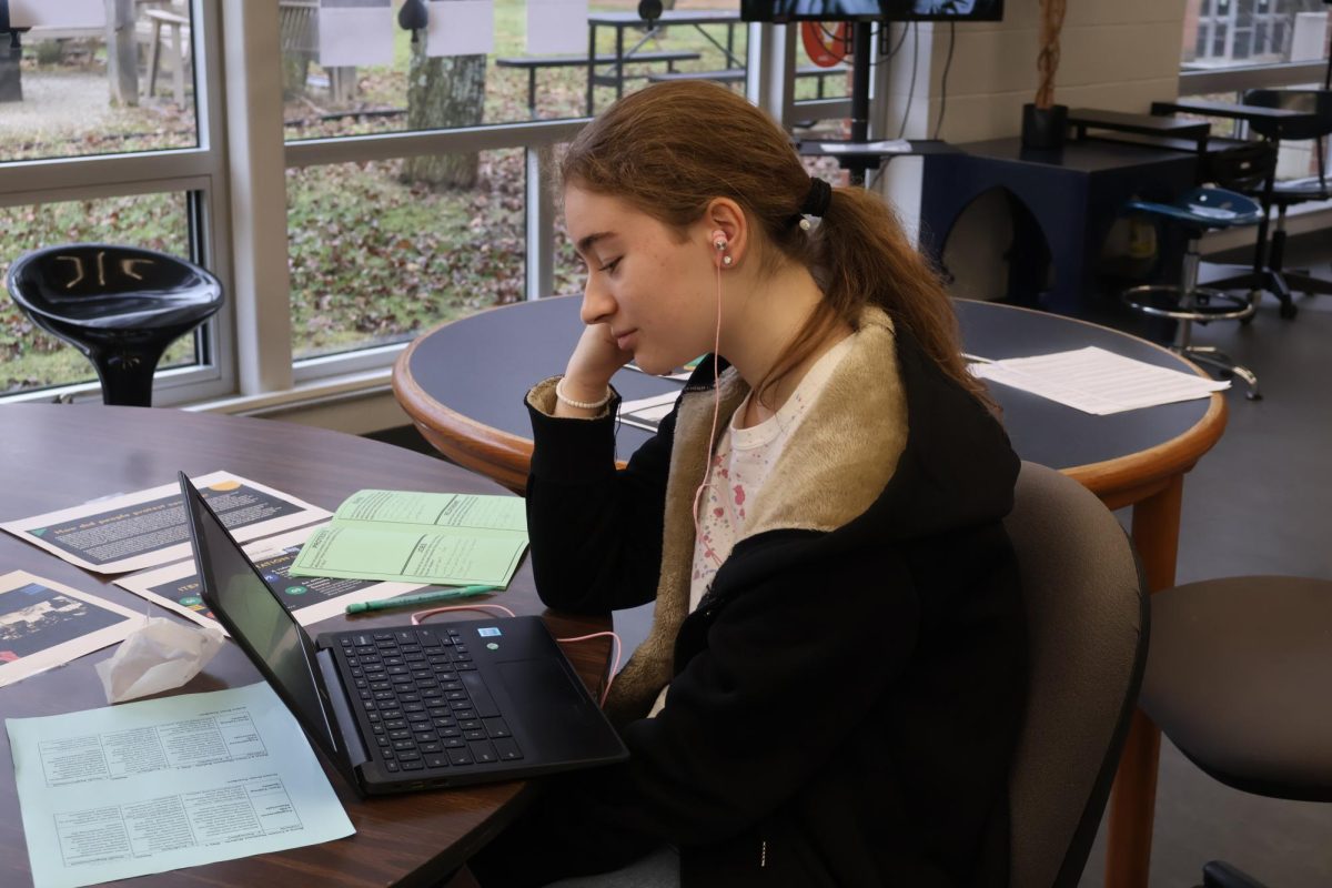 Olivia Power (10) watches a video and takes notes for her future project. 