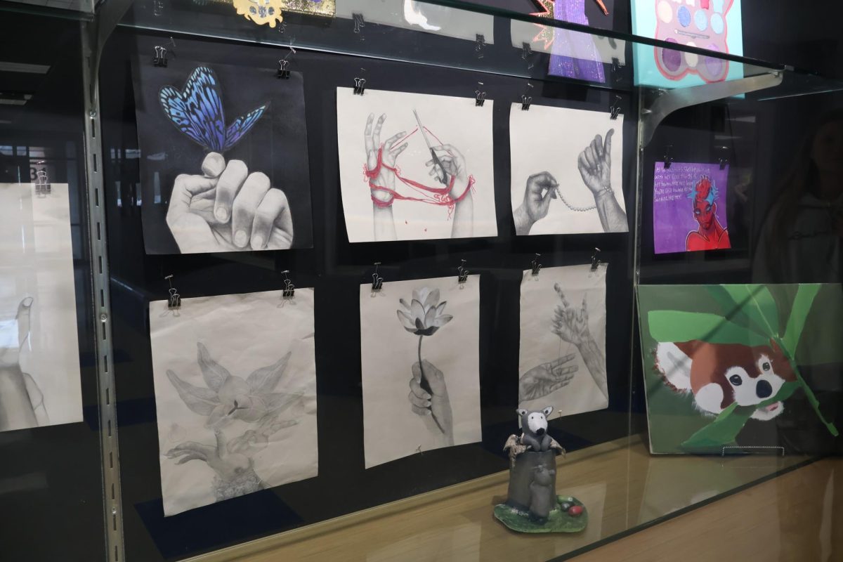 Art students in Ms. Tinnel's class work hard during their class time to get their project ready for the display. 