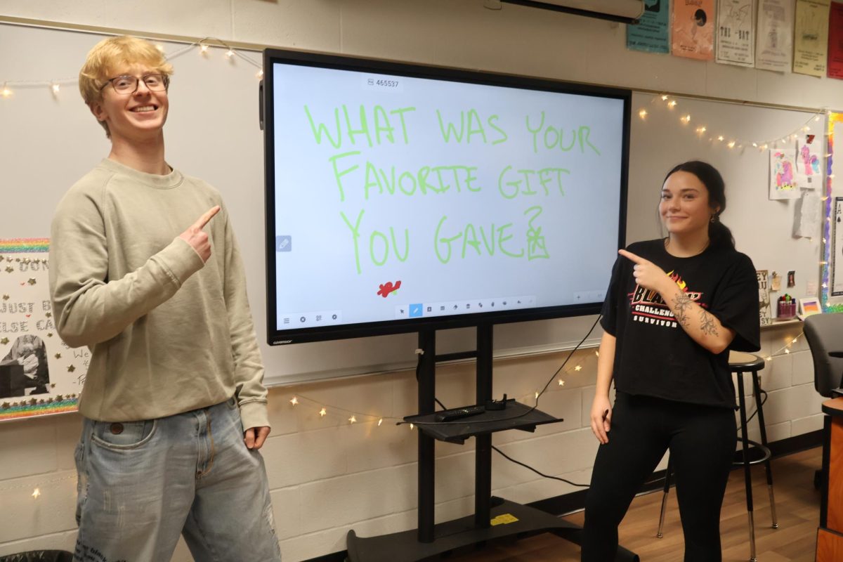 Lane Wymer (11) and Alex Gowans (12), pose in front of their question of the day in Mrs. Rodockers drama class.