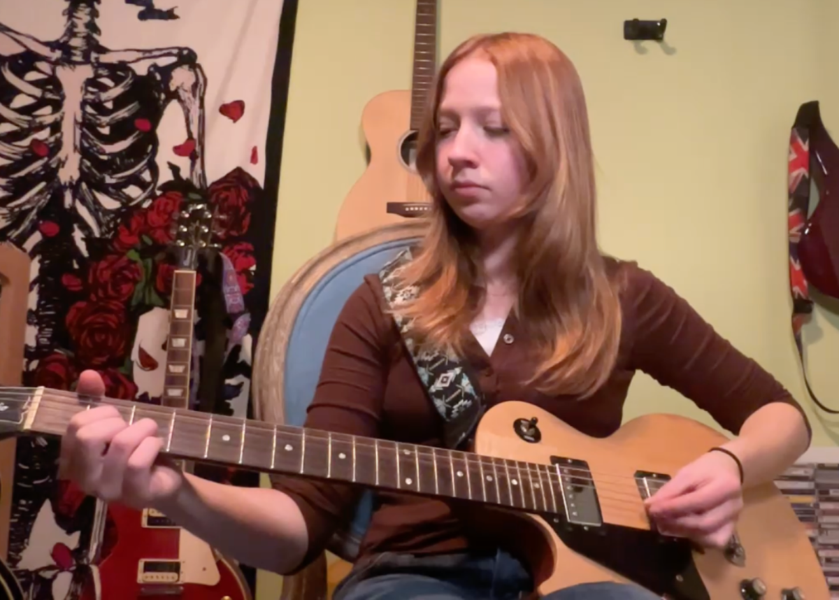 Neko plays her main guitar.
