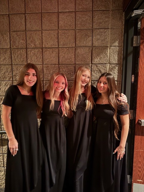Sophomores Kamber Cramer, Gwyn Whittington, Elvi Kelly, and Lily Rapp lining up to support their friends during the concert. 