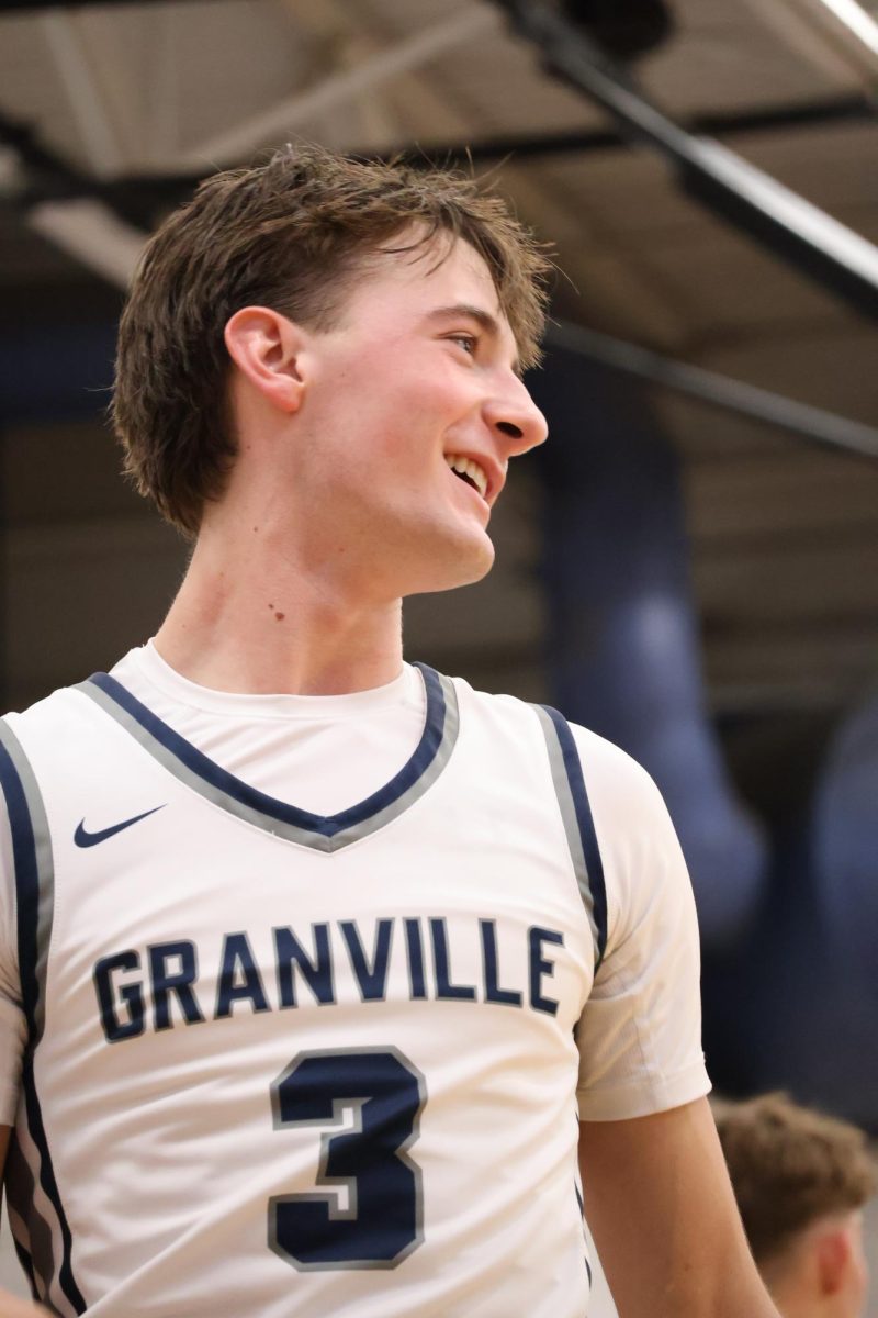 Senior Keegan Cross smiles as he watches his teammates make a play. This was just minutes before the boys added another win to their stat line.