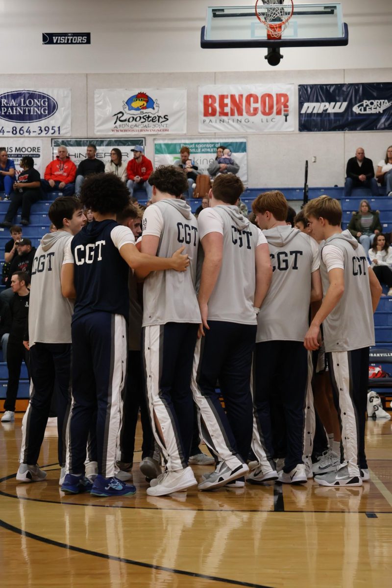 The Granville Boys Basketball team gathers closely to discuss the upcoming game plan before tip-off. The players were well-prepared and ready to go back to the court after a successful warm-up session.