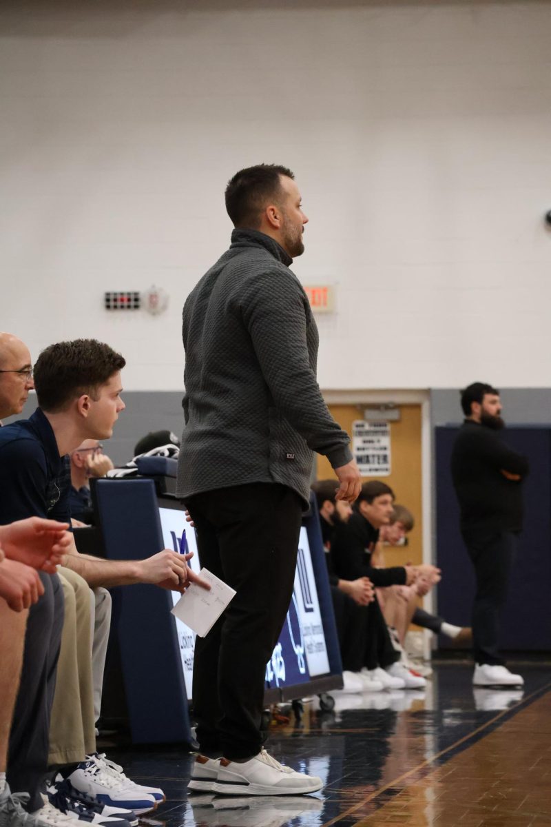 Coach Gibson directs the team from the sidelines as the pressure of the quarter builds. The players relied on his constant encouragement to stay focused during the game.