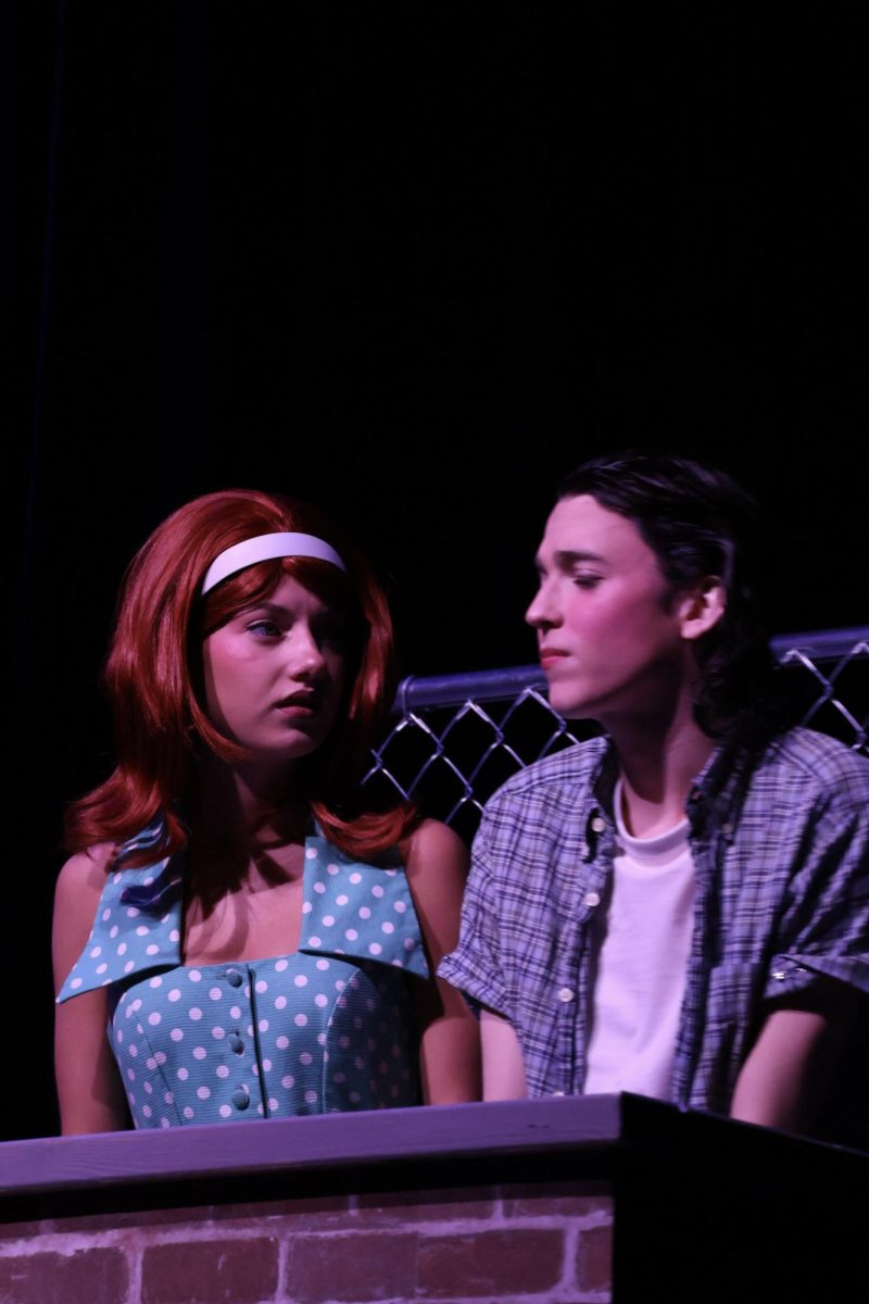 Sophomore Clara Dandurand, and Senior Sam Hannig performing drive-in movie scene during The Outsiders.