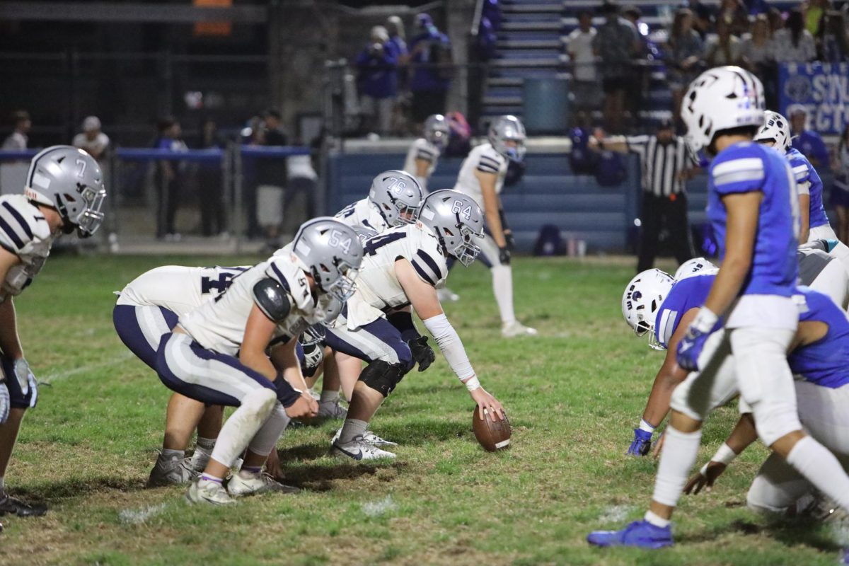 Junior Ian Roberts gets ready to snap the ball and defend against Washington Quarthouse. 