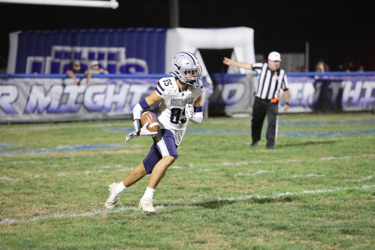 Freshman Carter Ryhan catches the punt and runs down the field to get closer to the Blue Aces end zone. 