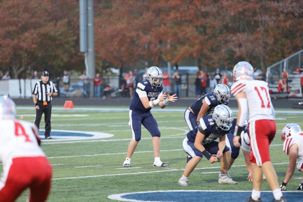 Jackson McMillan (11) gets ready to catch the snap as he scans the field to get another Blue Aces touchdown. The Aces dominate Utica on their home turf for the homecoming game. 