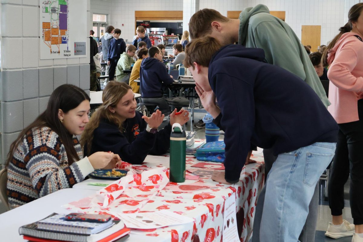 Students gather as they talk about the secret Valentine's day chocolate that is about to be sent out to the students.