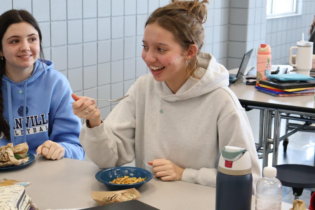 Sophomore Estelle Ames laughs with her table as they all joke around while at lunch.