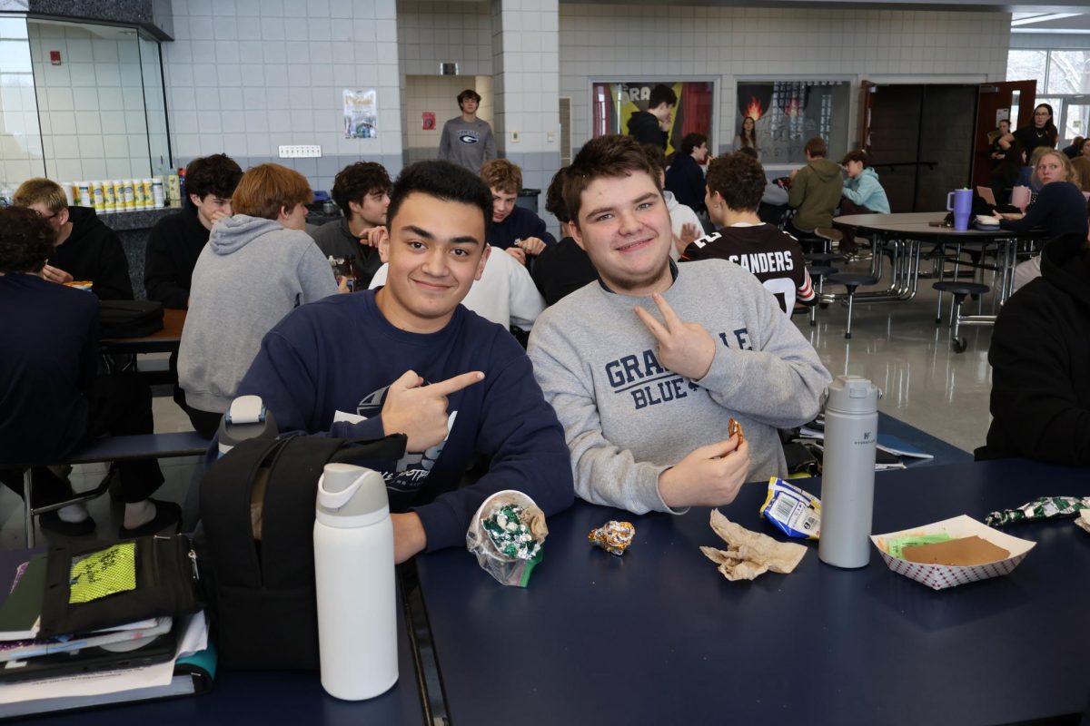 Sophomore Noah England and senior Aiden Findlay happily pose for a photo while they enjoy their lunch.