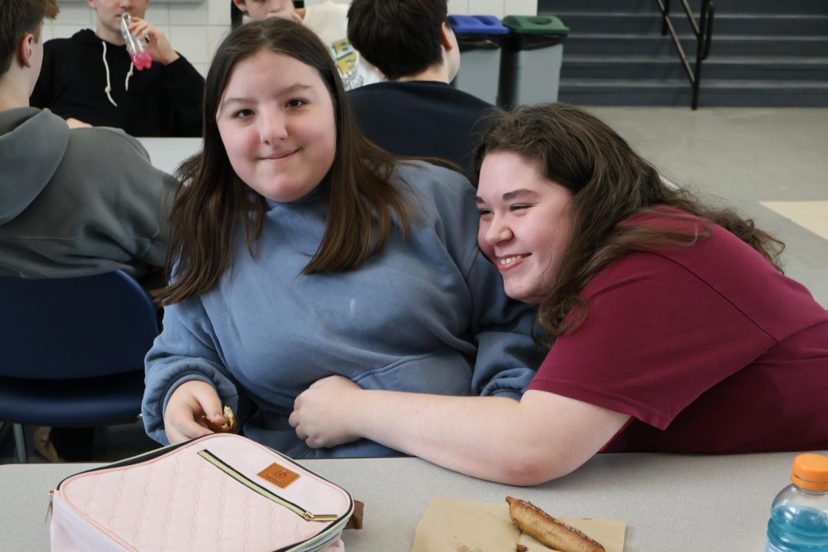 Sophomore Mimi Wood and Junior Aurora Womax pose for a photo as they enjoy their lunch.