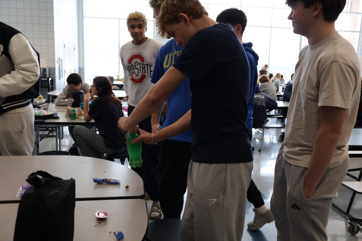 Sophomores Micheal Evans, Vinny Wiesler, Chris Langford and Cooper Duncan gather around a table as they experiment with foods and liquids at lunch.