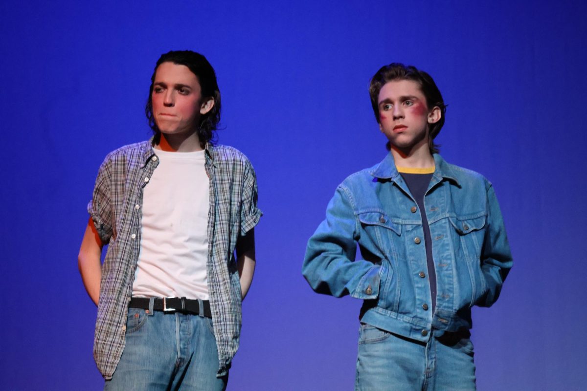 Ponyboy (Sam Hannig) and Johnny (Max Holtsberry) stand together after they get beat by the Socs. This will cause them to run away in hind as they killed Bob.