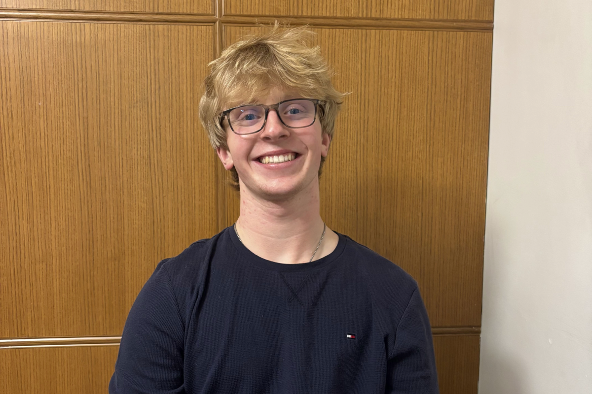 Lane Wymer smiles for a photo. He runs the business Premier Auto Aesthetic, where he details the interior and exterior of cars. 
