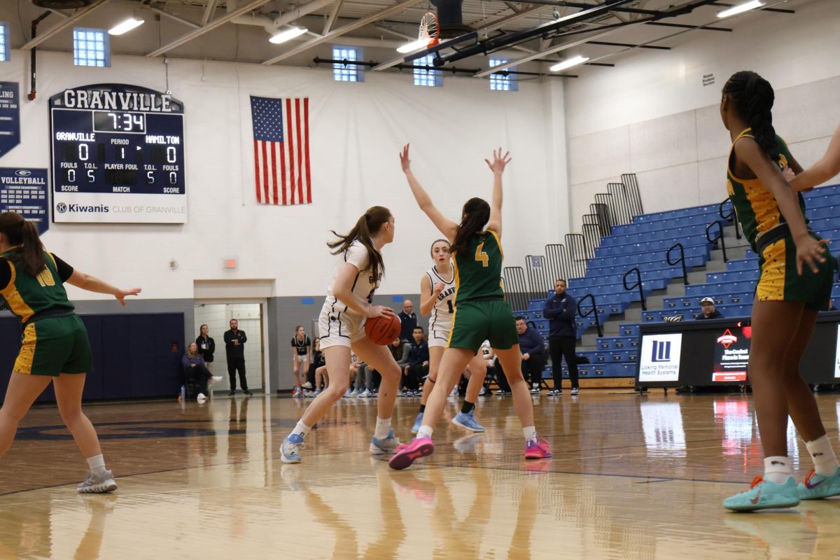Junior Elle Mortimer passes the ball to her teammate Junior Davyn Miller during the game. These two work together to get an easy layup. 