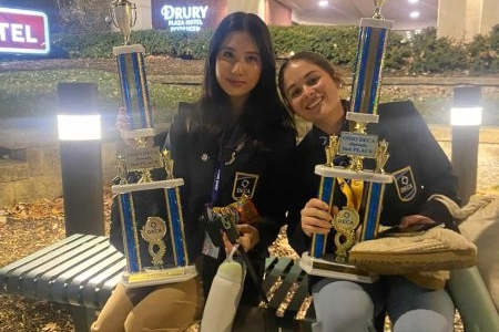 DECA Co-Presidents Zoe Richeimer-Lee and Avary King holding their trophies. Photo courtesy of Avary King