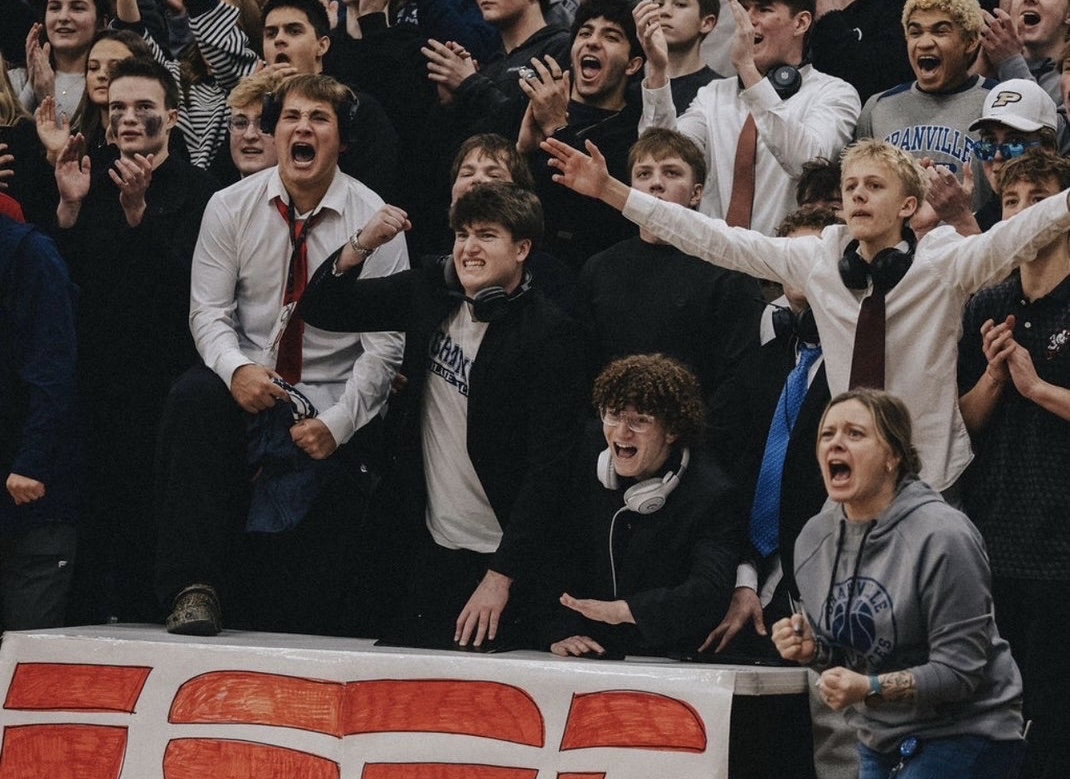 New AD Mrs. Wills (bottom right) celebrates a bucket with the student section at a girls basketball game.