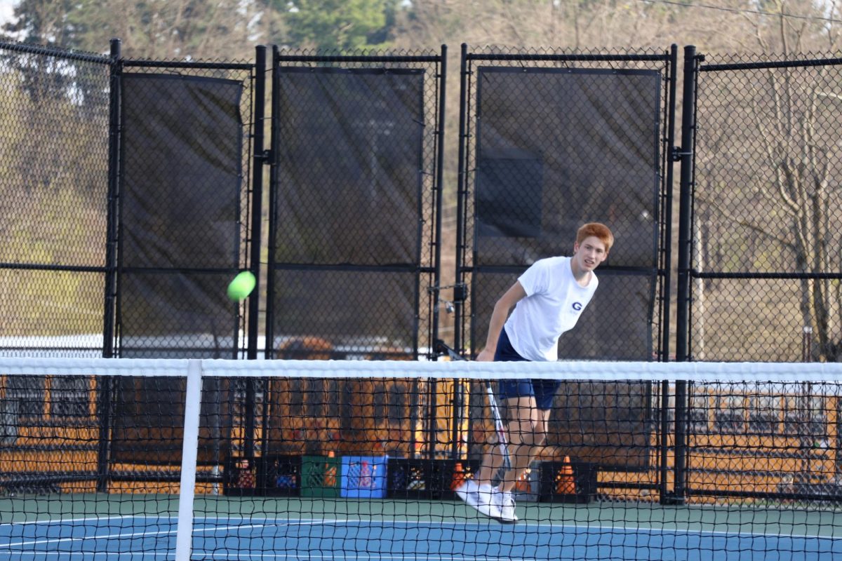 Junior Harrison Mckinney slams the ball to his opponent and continues to keep his eye on the ball to ensure that he is ready for the next shot. 