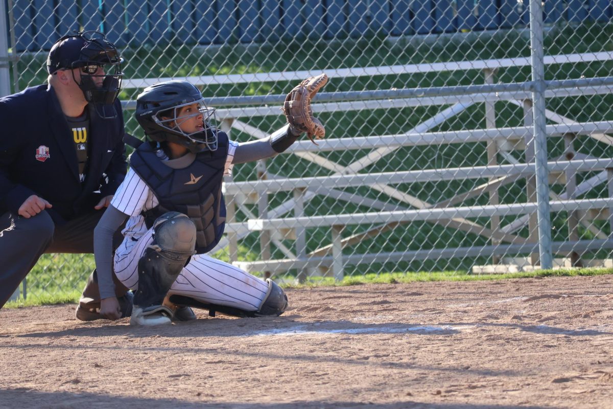 Sophomore Rubi Lechuga watches the ball and prepares to catch it. Lechuga was a team player having not typically being the catcher.