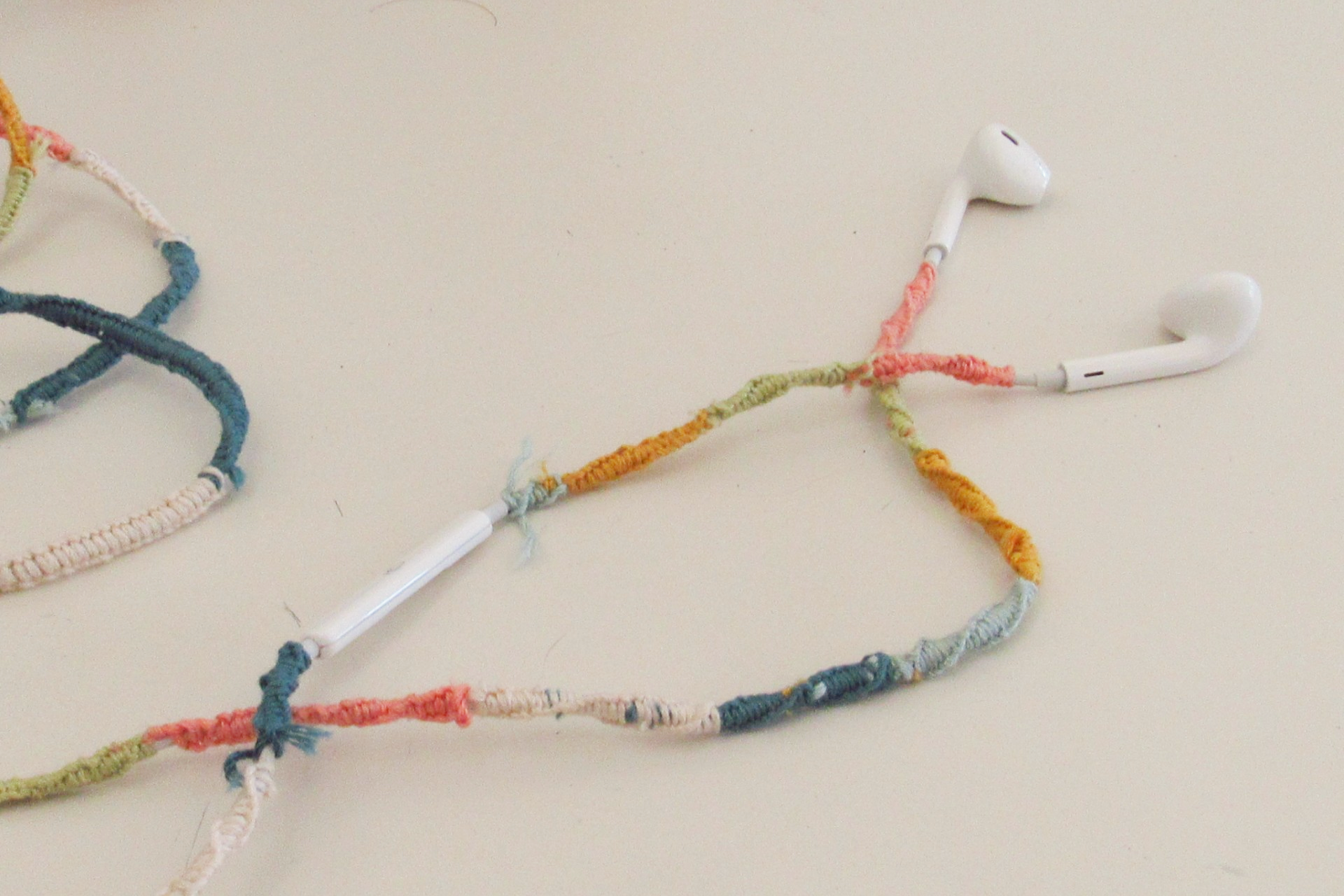 Wired headphones wrapped with embroidery thread. They were created by a student at GHS.