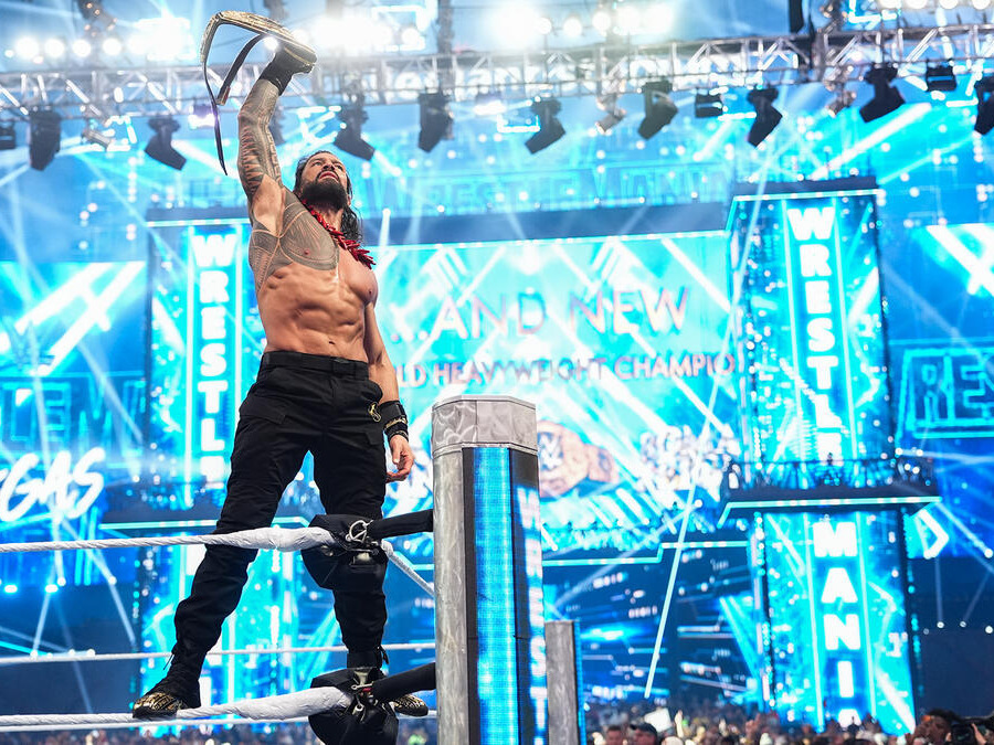Roman Reigns holds up his newly won WWE World Heavyweight Championship. Source: wwe.com
